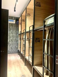 a row of wooden lockers in a hallway at Hostel Orto Say in Bishkek