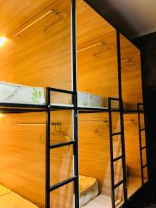 a bunk bed with a ladder in a room at Hostel Orto Say in Bishkek