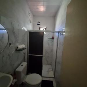 a bathroom with a shower and a toilet and a sink at Casa 01 simples e aconchegante em Maragogi in Maragogi +12 photos