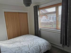 a bedroom with a bed and a window at The Annexe in Swanton Morley. in Swanton Morley