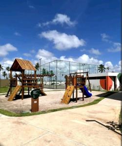 a playground with wooden play equipment in a park at Mana Beach Experience - 62m2 - 2 quartos - 1 Suite - com opcao de terreo tipo studio, 30m2 - Praia de Muro Alto in Porto De Galinhas