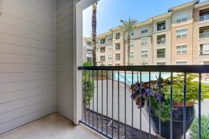 a balcony with a palm tree and a building at Houston Texas 1BR APT With pool view near NRG and MED CENTER in Houston