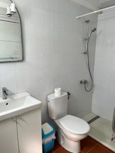 a bathroom with a toilet and a sink and a shower at La charquita in Famara +5 photos