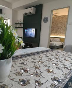 a living room with a table with a flower rug at Wanz Barakah Homestay @ Bali residence in Malacca