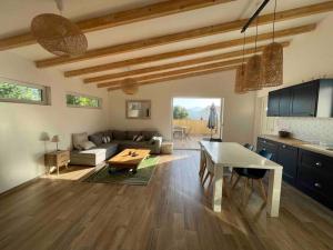 a living room with a couch and a table at Petite maison avec terrasse. in Ajaccio