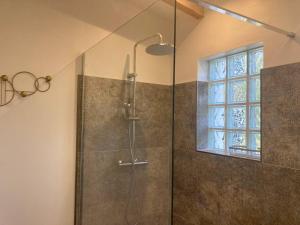 une salle de bain avec une douche avec une porte vitrée dans l'établissement Petite maison avec terrasse., à Ajaccio 13 autres photos