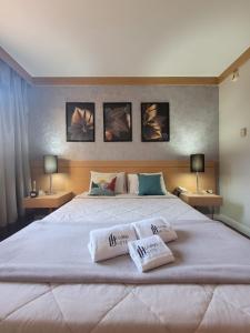 a bedroom with a large bed with two pillows on it at Studio Living Faria Lima in Sao Paulo