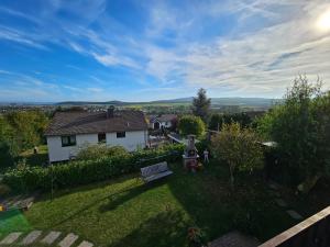 a view of a yard with a bench and a house at Ferienwohnung Talblick in Weimar