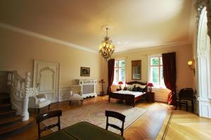 a large living room with a couch and a piano at Schloss Langenzell, Fürstensuite in Wiesenbach