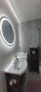 a bathroom with a white sink and a mirror at Apartament CityStation in Wałbrzych +23 photos