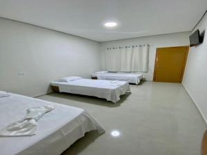 a hospital room with two beds in it at AMPARO HOTEL in Ribas do Rio Pardo