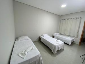 a hospital room with two beds and a window at AMPARO HOTEL in Ribas do Rio Pardo