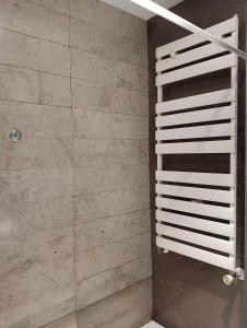 a bathroom with a shower with marble tiles at Le lagon de Hammamet in Hammamet +65 photos