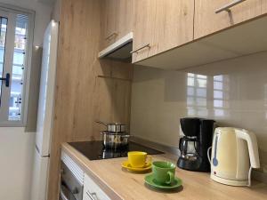 a kitchen with two cups and a coffee maker on a counter at Bright lovely quiet flat very centric in SC in Santa Cruz de Tenerife