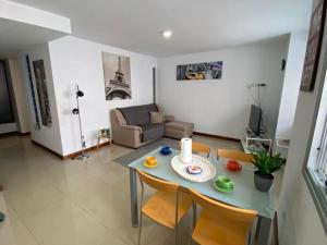 a living room with a table and a couch at Bright lovely quiet flat very centric in SC in Santa Cruz de Tenerife