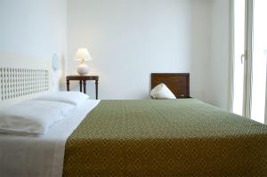 מיטה או מיטות בחדר ב-Residence Castello Otranto