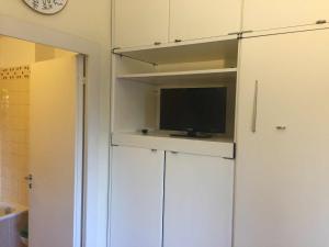 a tv on top of a white cabinet in a bathroom at Eurotel 312 in Rapallo
