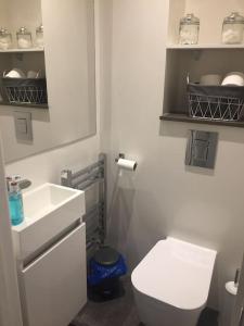 a white bathroom with a toilet and a sink at Barn conversion, Old Hatfield, Herts Just a few minutes walk to Hatfield train station and Hatfield House in Hatfield +10 photos