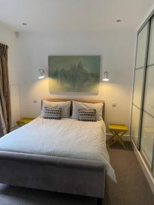 a bedroom with a large bed with two pillows at Barn conversion, Old Hatfield, Herts Just a few minutes walk to Hatfield train station and Hatfield House in Hatfield