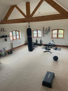 a gym with a punching bag in a room at Dairy farm in Crewe