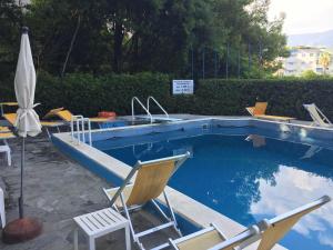 a swimming pool with chairs and a sink in it at Eurotel 406 in Rapallo +21 photos