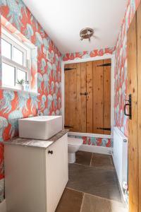 a bathroom with a sink and a toilet and a window at No93 Boutique Guest House in Easingwold