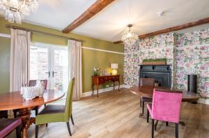 a dining room with tables and chairs and a fireplace at No93 Boutique Guest House in Easingwold