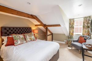 a bedroom with a bed and a chair at No93 Boutique Guest House in Easingwold