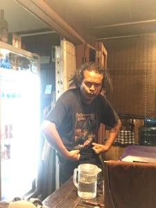 a man standing at a table in a kitchen at Imchai in Pai