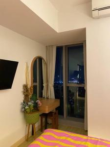 a bedroom with a desk and a table with a window at 1BR ~ The Charming Branz by lalerooms CLOSE TO ICE in Samporo