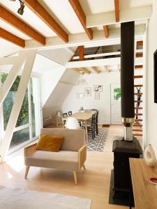 a living room with a couch and a table at Chalet en Normandie au coeur du pays d'Auge in Le Pin