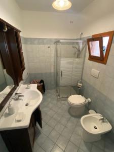a bathroom with a sink and a toilet and a shower at CASA ALTOMARE in Otranto