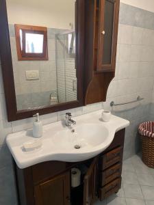 a bathroom with a white sink and a mirror at CASA ALTOMARE in Otranto
