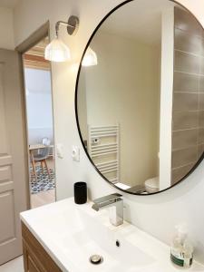 a bathroom with a large mirror over a sink at Chalet en Normandie au coeur du pays d'Auge in Le Pin