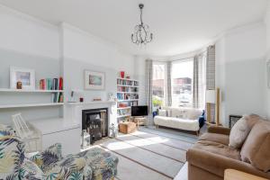a living room with a couch and a fireplace at Hove garden flat, pet friendly in Brighton & Hove