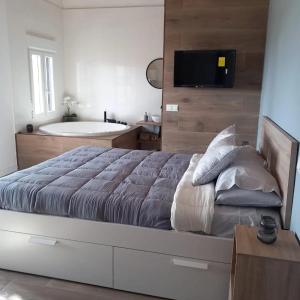 1 dormitorio con 1 cama grande y bañera en Bungalow Sierra San Vicente, en Hinojosa de San Vicente