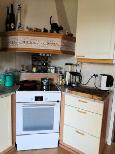 a kitchen with a white stove and a sink at Homestay cozy hosting in Tervakoski
