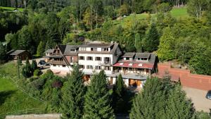 an aerial view of a large house with trees at La source in Sondernach