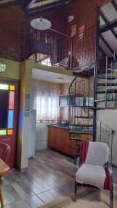a kitchen with a spiral staircase in a room at Recanto Pôr do Sol in Nova Petrópolis