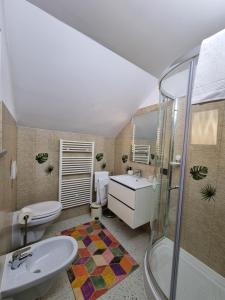 a bathroom with a sink and a toilet and a shower at Comfy House in Borşa +15 photos