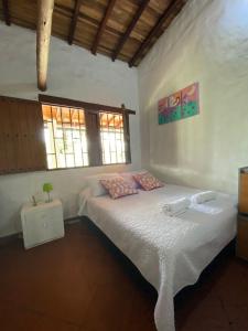 a bedroom with two beds and a window at Villa tolu in San Gil +21 photos