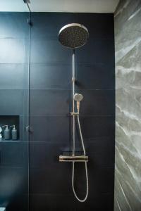 a shower with a shower head in a bathroom at Namara Green Ella in Ella