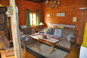 a living room with a couch and a table at Altes Bauernhaus in Gnesau