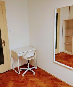 a white desk in a room with a mirror at Apartman Coral in Prague