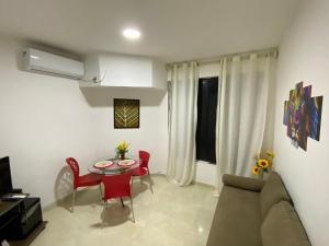 a living room with a couch and a table at Apartamento Vilage na Praia de Armação Salvador in Salvador