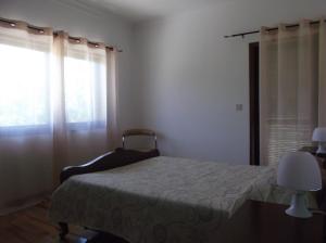 
a bedroom with a bed and a dresser at Albergue Constantino AL in Paredes de Coura
