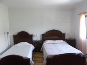 a bedroom with two beds and a window at Albergue Constantino AL in Paredes de Coura +39 photos