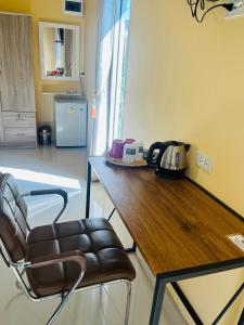 a kitchen with a wooden counter and a chair at Koh Yao Modern Inn -SHA Plus in Ko Yao Yai