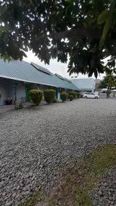 a building with a gravel driveway in front of it at OYO 931O12 Tamara Homestay Syariah in Medan