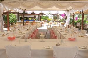 a group of tables with white tablecloths at Makronisos Village in Ayia Napa